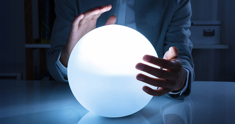 A business person using a crystal ball to predict the future