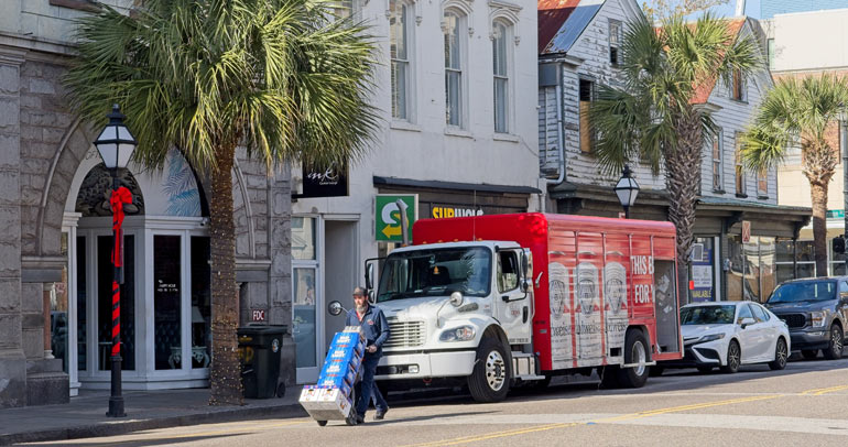 A truck driver of a class 6 commercial vehicle making a delivery