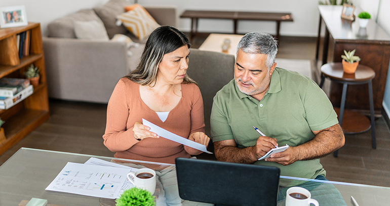 A couple in Texas going over their energy expenses on their laptop at home