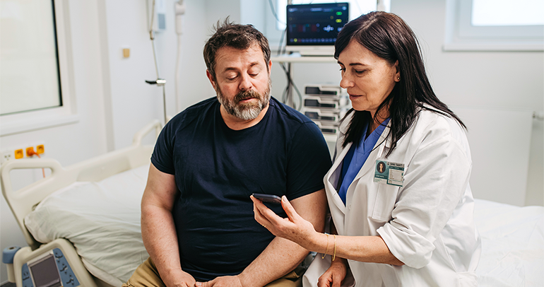 Patient and doctor reviewing digital device