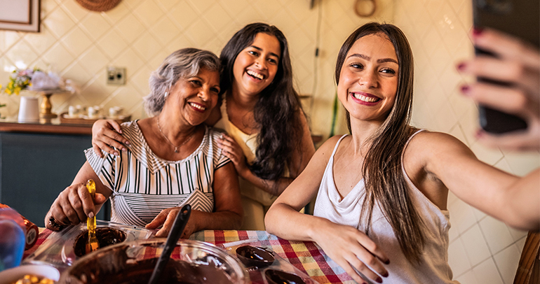 3 women smiling and clicking a selfie