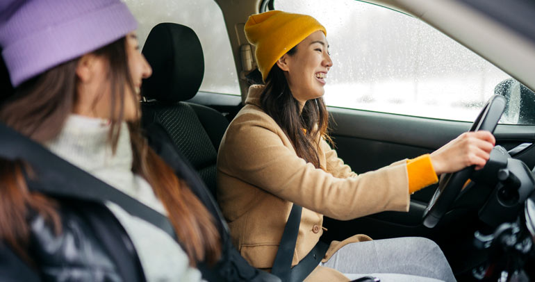 Two women in a car on a road trip