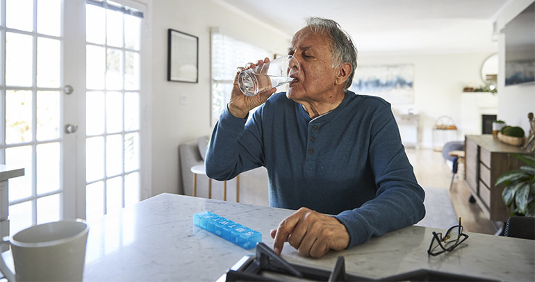 A sick person drinking water