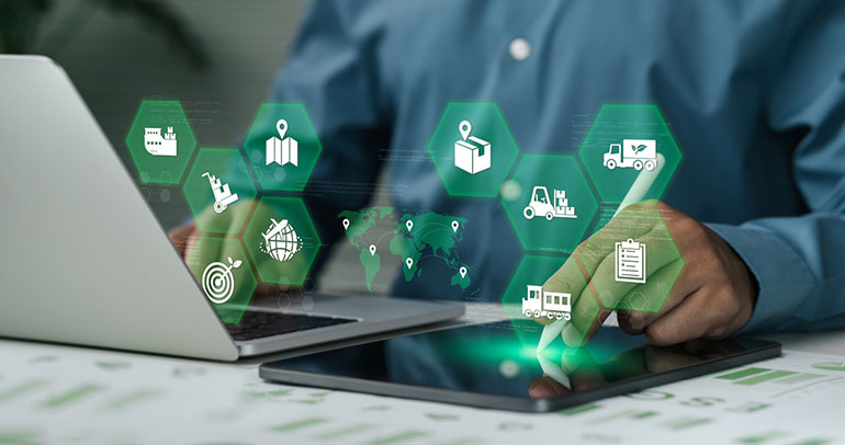 A fleet manager monitoring a telematics program from their laptop and tablet