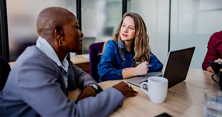 Two colleagues discussing in a meeting room