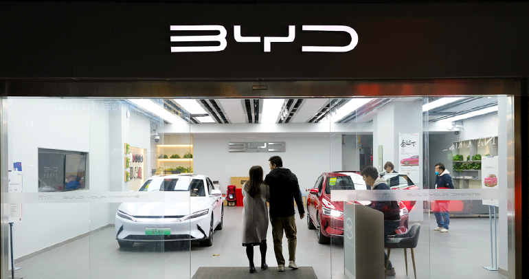 Two people walking into the BYD dealership